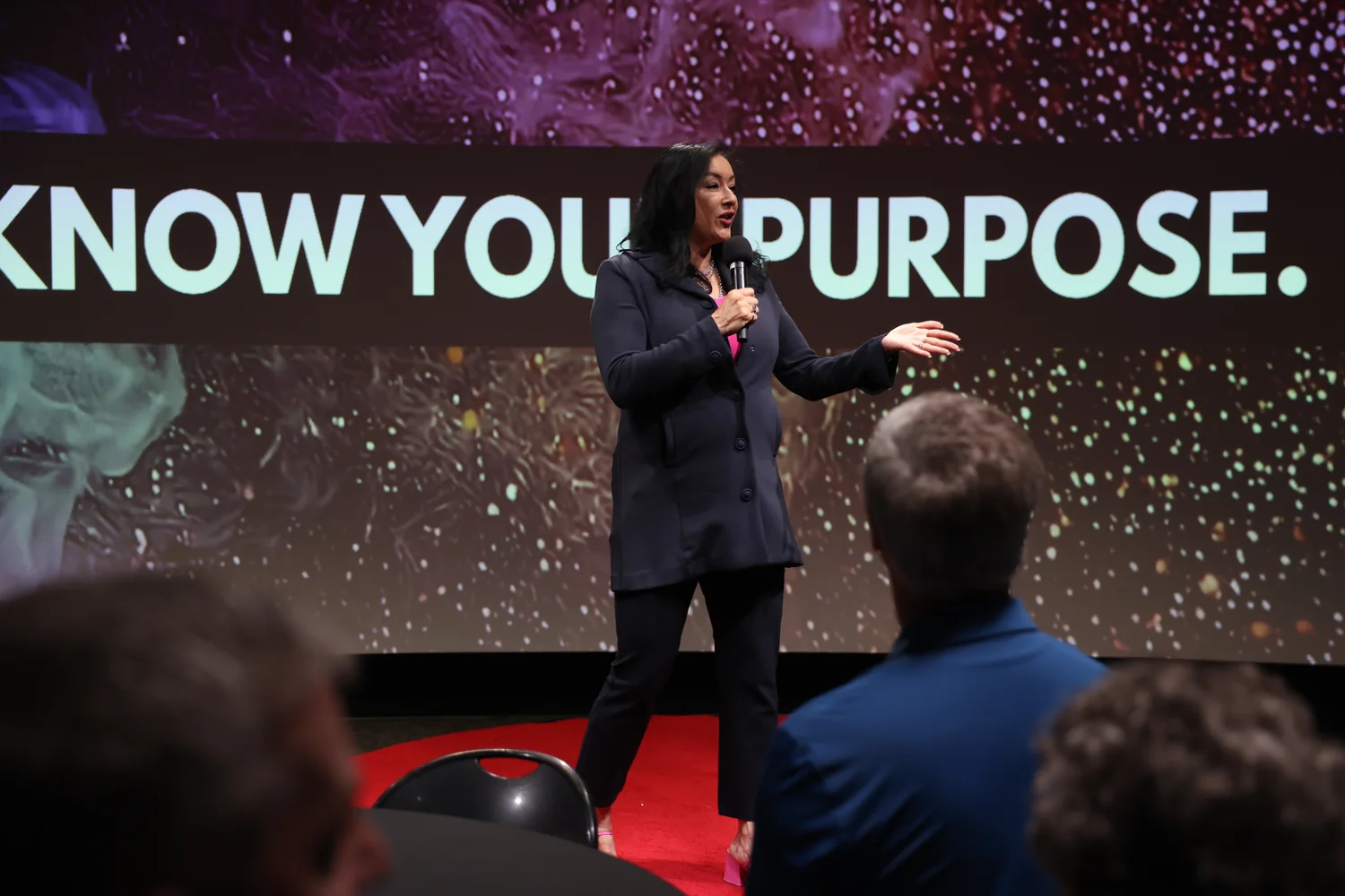 Blanca Criner delivering a keynote on stage to an audience